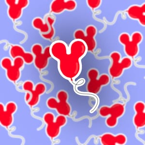 May include: A red balloon shaped like Mickey Mouse ears against a light blue background. The balloon has a white string attached to it.