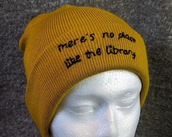 Hand embroidered "There's no place like the library" beanie hat