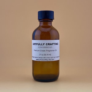 May include: A brown glass bottle with a black cap, labeled "Artfully Crafting Gingerbread Premium Grade Fragrance Oil 2 fl oz (59.14 ml)".
