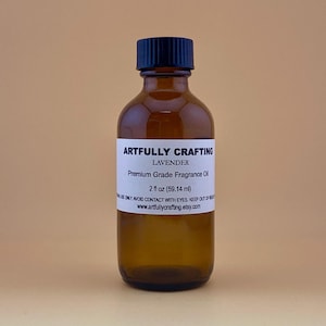 May include: A 2-ounce amber glass bottle with a black cap, labeled "Artfully Crafting Lavender Premium Grade Fragrance Oil". The label also includes the website address "www.artfullycrafting.etsy.com".
