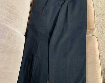 May include: A pair of black pleated pants with a button fly and belt loops.