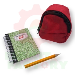 May include: A miniature school supplies set featuring a red backpack, a spiral-bound composition book with the text "ELF", and a yellow pencil. The composition book has a green speckled cover.