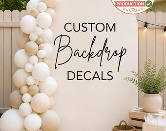 May include: A large arched white backdrop featuring the black text CUSTOM Backdrop DECALS. A vertical garland of white and beige balloons is attached to the left side. A circular stamp in the top right corner reads PROOF SENT FOR APPROVAL BEFORE PRODUCTION.