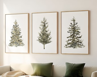 Pode incluir: Três pinturas de aquarela emolduradas de pinheiros verdes sobre um fundo branco. As molduras são de cor dourada clara.