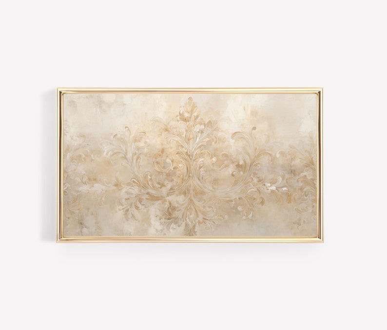May include: A framed wall art print with a gold frame. The print features a beige background with a gold, intricate, symmetrical design.