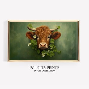 May include: A painting of a brown cow's head with a green leafy background. The cow has a white nose and white markings around its eyes. The leaves are green and have white flowers.