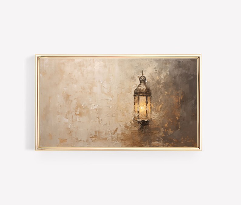 May include: A framed painting depicting a lantern hanging against a textured, beige background. The lantern is made of metal and has a glass window with a warm glow emanating from inside.