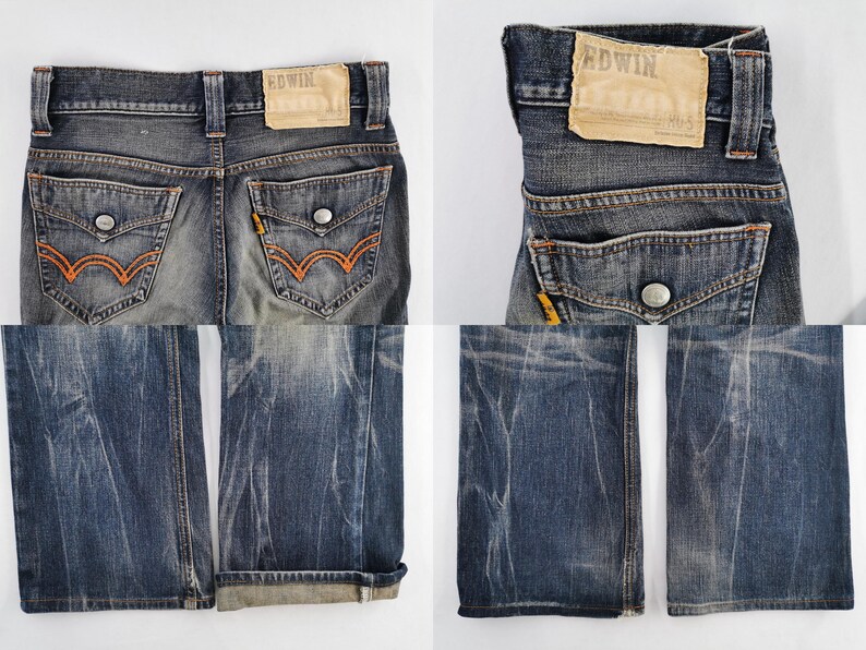 Op de afbeelding: Close-up van een verbleekte blauwe spijkerbroek met oranje stiksels op de achterzakken. De jeans hebben een versleten look, met een leren patch op de tailleband. De merknaam "EDWIN" is zichtbaar op de patch.
