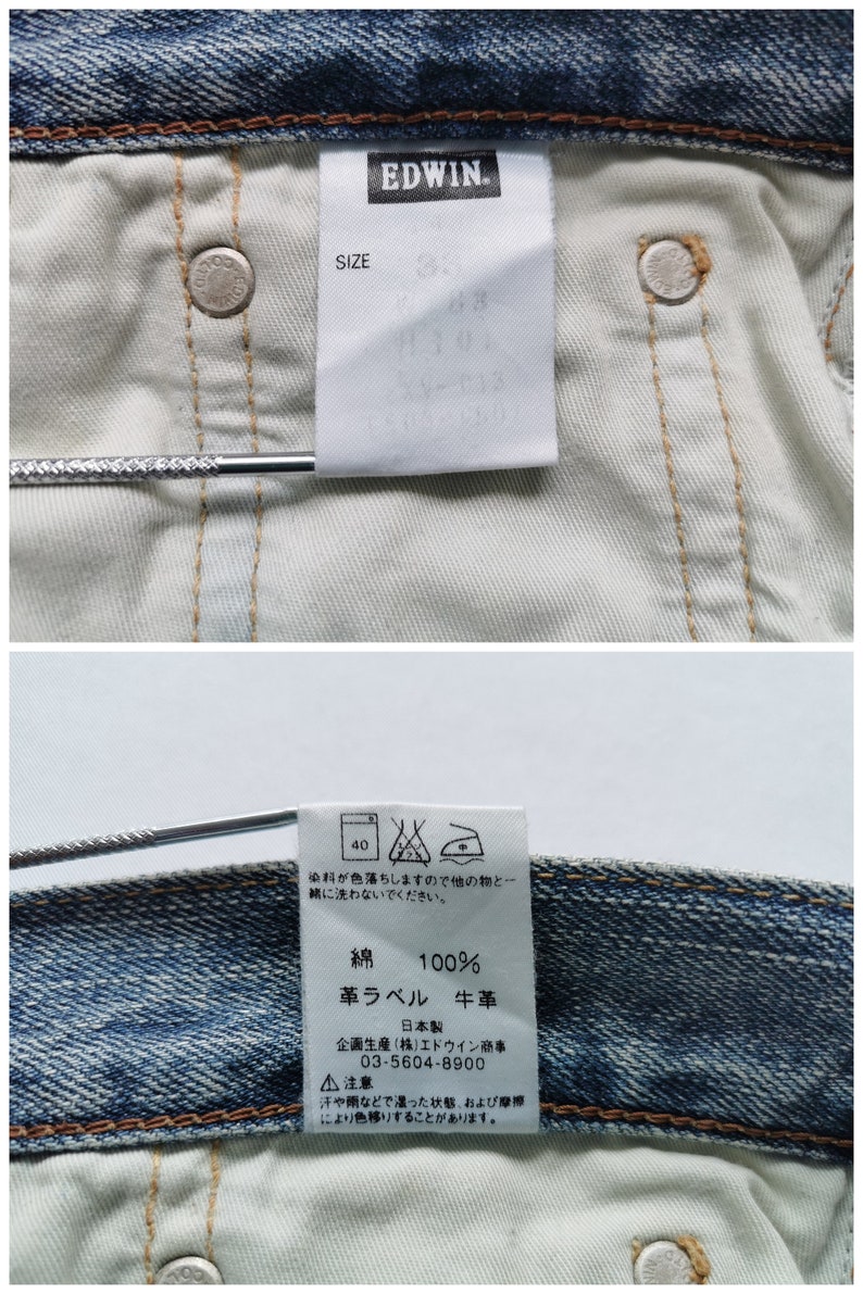 May include: Detailed view of the inside of blue denim jeans, featuring the "EDWIN" brand label and a size tag. The tags display care instructions and material details, including 100% cotton. The jeans have metal rivets and a light-colored interior.