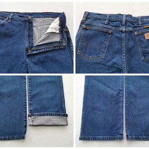 May include: Multiple views of blue denim jeans. The jeans have a button and zipper closure, pockets, and a brown leather patch on the back. The jeans are folded at the bottom hem.