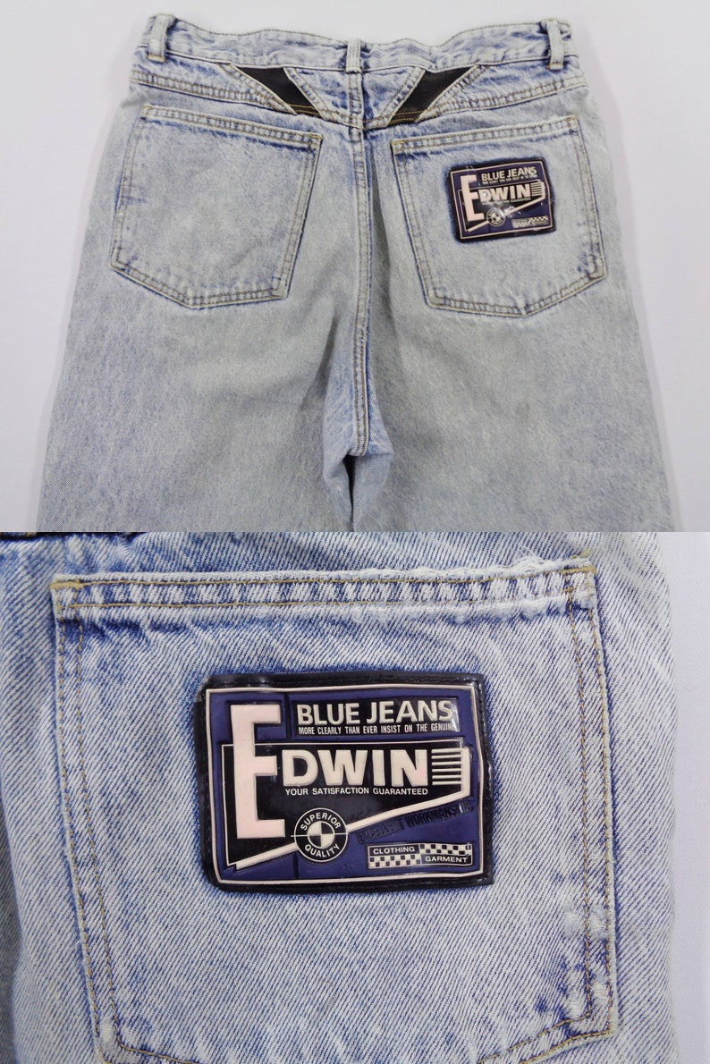 May include: Light blue denim jeans with a faded wash. The back features two pockets and a black leather patch detail at the waistband. A rectangular patch on the back pocket reads "BLUE JEANS" and "EDWIN".