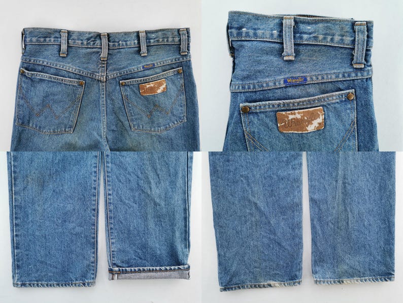May include: Light blue denim jeans with a classic five-pocket design. The jeans feature a brown leather patch on the back pocket with the Wrangler logo. The jeans have a straight leg cut and a faded wash.