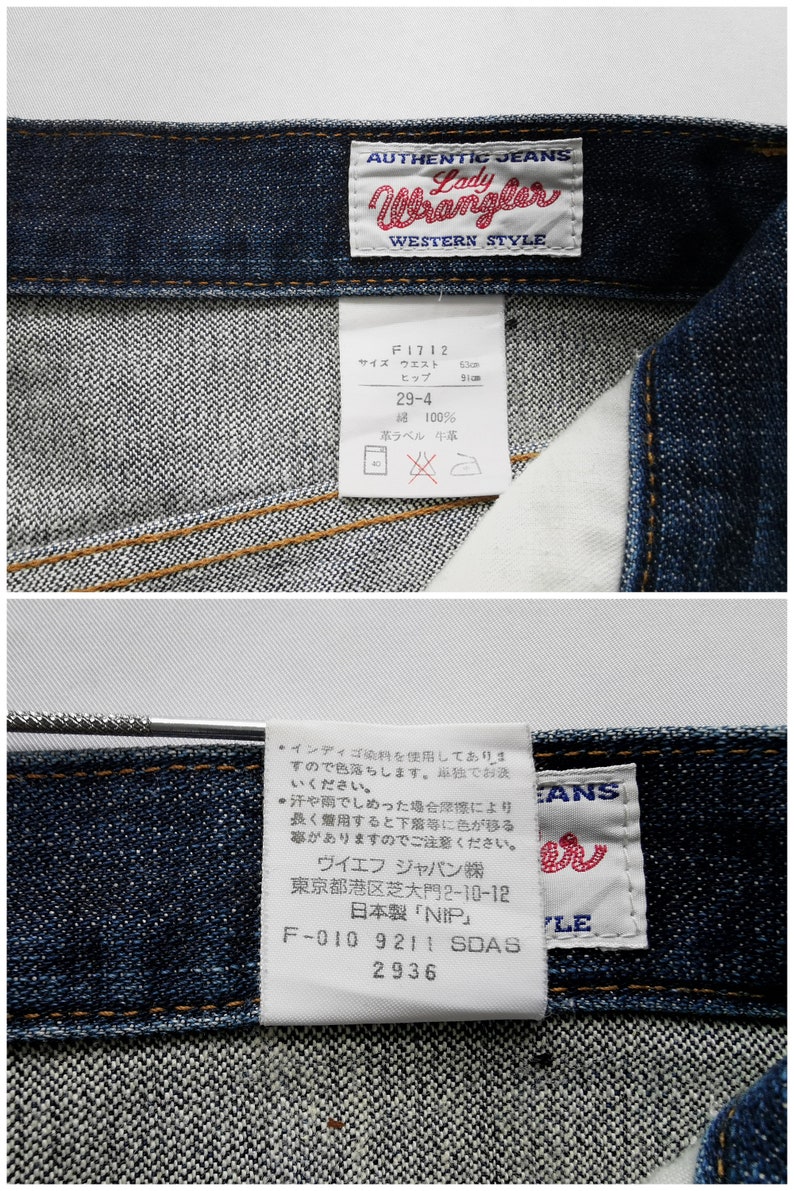 May include: Close-up of dark wash denim jeans with the "Lady Wrangler" label. The label includes the text "AUTHENTIC JEANS WESTERN STYLE". A tag shows waist size 63cm and hip size 91cm. The jeans are made of 100% cotton.