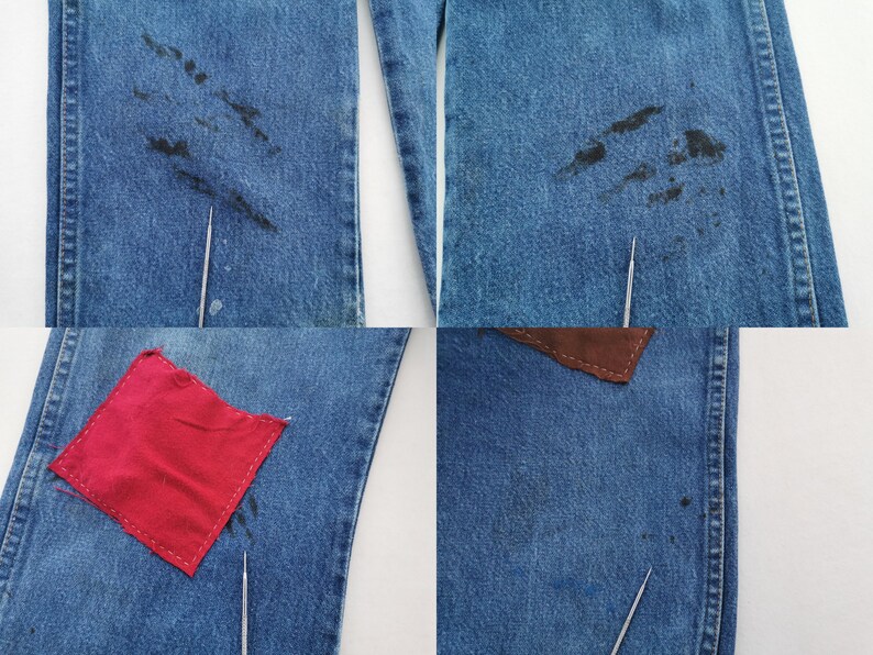 May include: Blue denim jeans featuring dark black stains on the upper thigh areas, a square red fabric patch stitched onto the lower leg, and a brown leather-like patch near the waist, with thin metal needles pointing to specific spots.