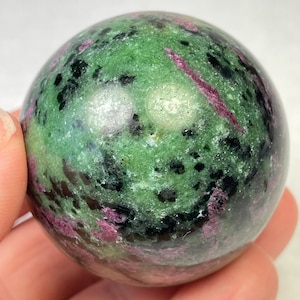 May include: A set of three ceramic vases in varying sizes and shapes. The vases are glazed in a matte white finish, with a textured surface. The tallest vase is approximately 10 inches tall.