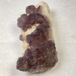 May include: A set of three ceramic mugs with a speckled, matte finish. The mugs are in shades of cream, light gray, and dark gray. Each mug has a simple, modern design and a rounded handle. Perfect for coffee or tea.