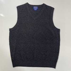 May include: A dark charcoal gray V-neck sweater vest with a ribbed neckline, armholes, and hem. The garment features a blue Pendleton brand label sewn into the inner collar area, indicating the manufacturer of this sleeveless knit pullover piece.