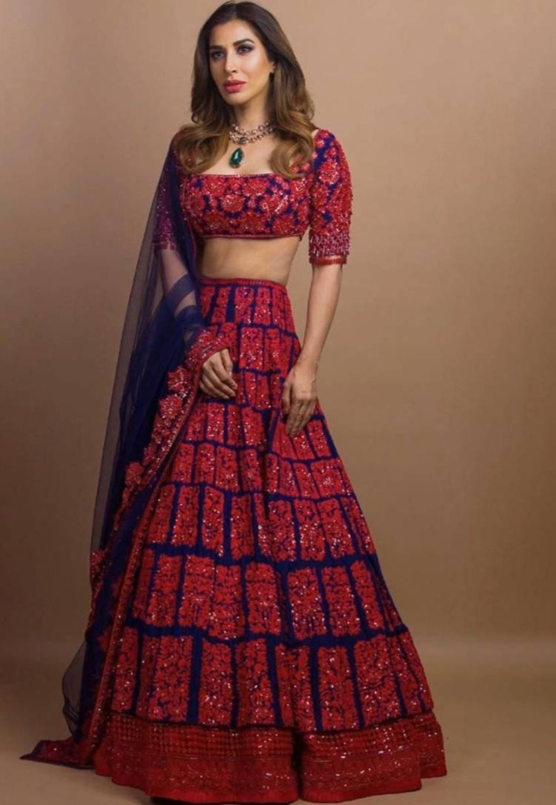 red lehenga and blue suit combination