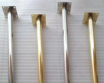 May include: Four metal table legs, two gold and two silver, with a square plate at the top and a round ball at the bottom.
