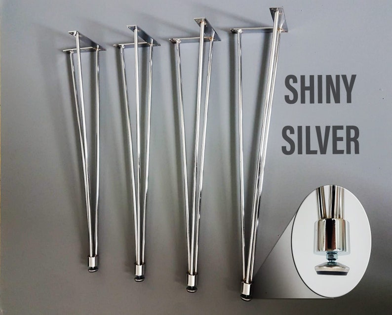 May include: Shiny silver hairpin table legs in varying heights. The legs have a sleek, modern design with a polished finish. The image includes a close-up of the adjustable foot. The text "SHINY SILVER" is displayed on the right side of the image.
