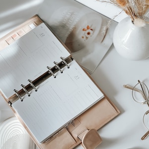 In this photo, the daily inserts are tucked into the planner without any labeling, ready for your customized planning.