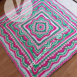 May include: A square, crocheted blanket in shades of pink, green, and white. The blanket features a detailed, geometric pattern with scalloped edges and a central square design. The text "vcrochetpatterns.etsy.com" is visible.