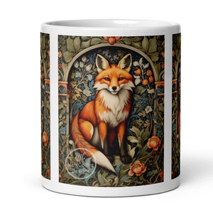 May include: A white ceramic mug with a colorful illustration of a fox sitting in a floral archway. The illustration is in a vintage style with intricate details. The mug has a white rim and handle.
