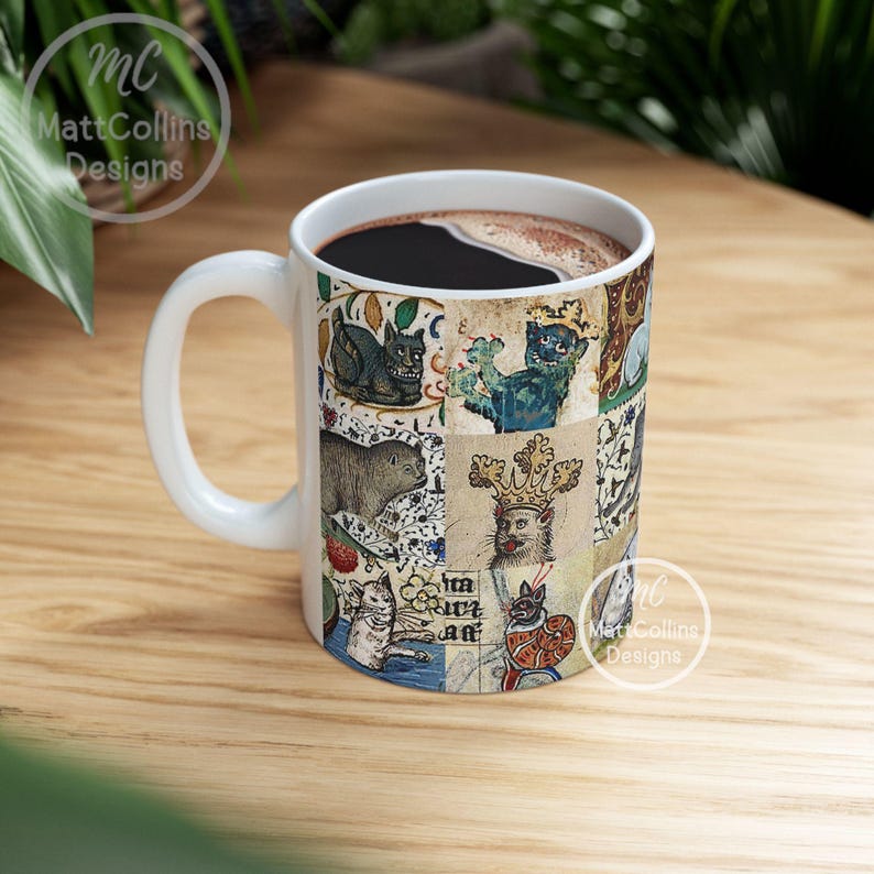May include: White ceramic coffee mug with a handle, filled with dark liquid. The mug features a collage of medieval-style illustrations of cats, animals, and text. The mug has the text "MattCollins Designs" on it.