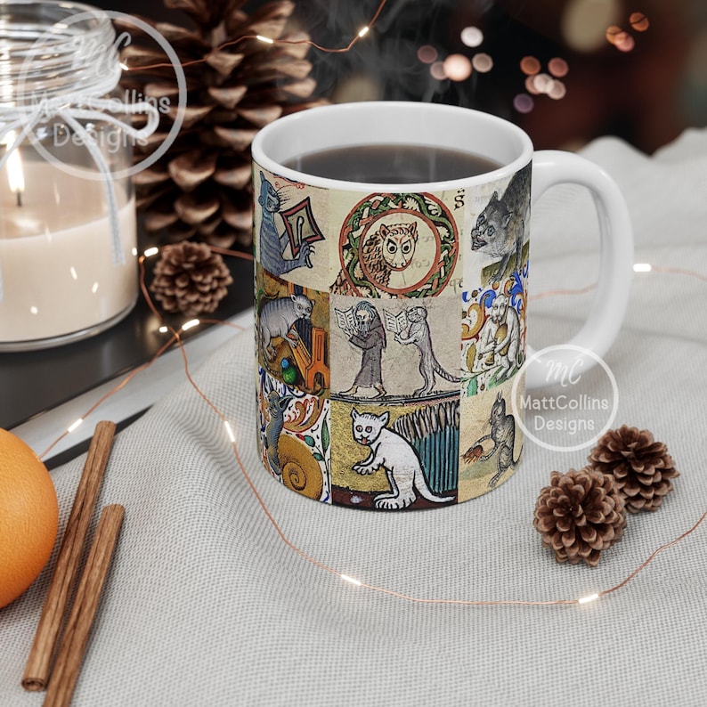May include: White ceramic mug featuring a collage of medieval-style illustrations of cats and other creatures. The mug has a white handle and is filled with a dark liquid. The design includes an owl, cats reading books, and other whimsical figures.