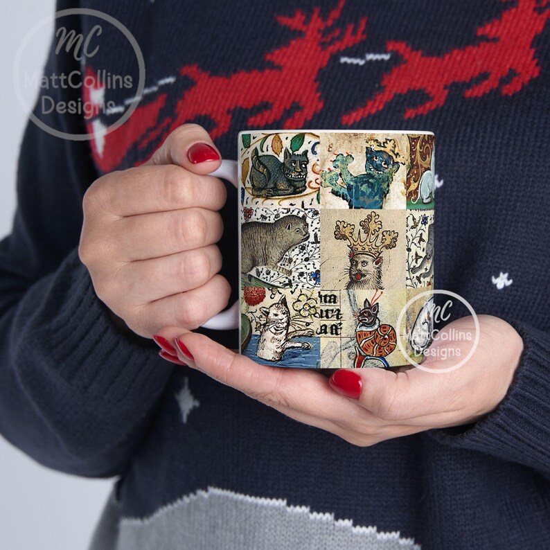 May include: White ceramic mug featuring a collage of medieval-style cat illustrations in various poses and colors. The artwork includes cats with crowns, in armor, and other whimsical designs. The mug has a white handle and the text "Matt Collins Designs" is visible.