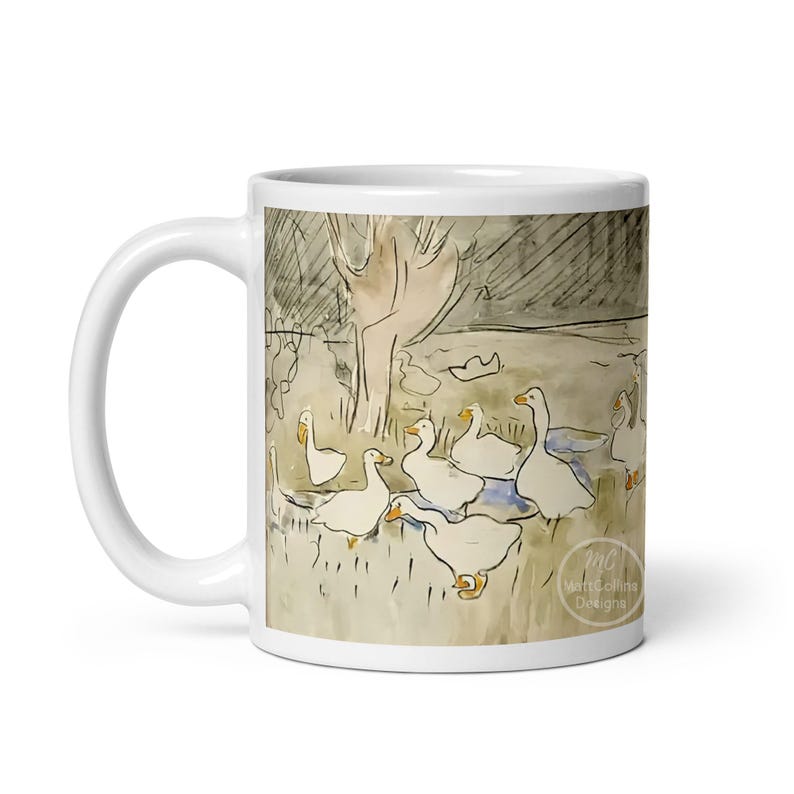 May include: White ceramic mug with a watercolor illustration of a group of geese in a field. The geese are white with orange beaks and feet. The background is a light brown with a dark brown tree in the center. The text "MC Martha Collins Designs" is printed on the bottom right corner of the mug.