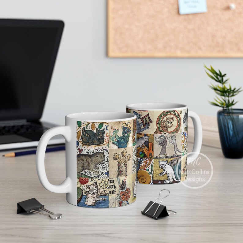 May include: White ceramic coffee mug featuring a collage of medieval cat illustrations in various poses and settings. The artwork includes cats in crowns, armor, and other whimsical scenes. The mug has a curved handle and a glossy finish.