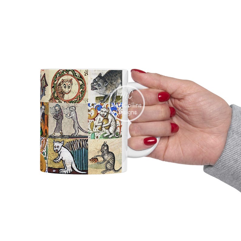 May include: White ceramic mug featuring a collage of medieval illustrations of animals and figures. The artwork includes an owl, cats, and other creatures in a vintage style. The mug is held by a person with red nail polish.