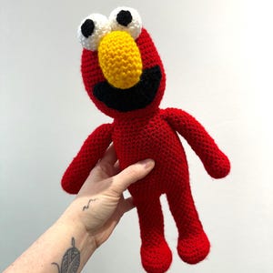 May include: A set of three ceramic mugs with a speckled, matte finish. The mugs are in shades of cream, light gray, and dark gray. Each mug has a simple, minimalist design and a rounded handle.