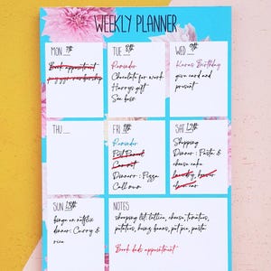 weekly planner showing weeks with a line to allow customer to write the date. The calendar is around A6 has small boxes to add your plan. The calendar has a blue background with floral patterns.This calendar has date and events written on it.
