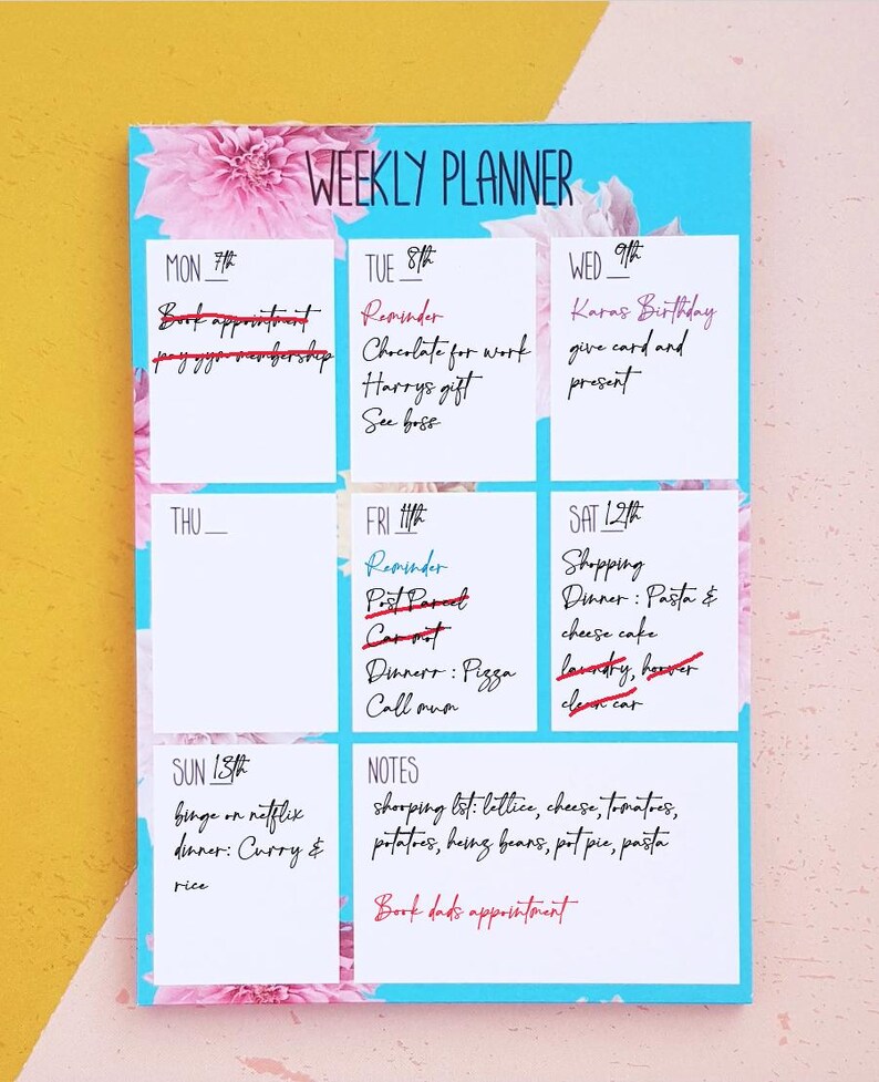 weekly planner showing weeks with a line to allow customer to write the date. The calendar is around A6 has small boxes to add your plan. The calendar has a blue background with floral patterns.This calendar has date and events written on it.