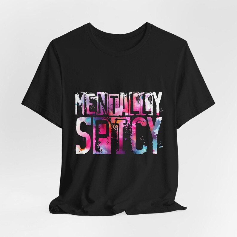 Puede incluir: Camiseta negra con la frase "MENTALLY SPICY" en un dise&ntilde;o colorido estilo acuarela. El texto est&aacute; en una fuente desgastada, a&ntilde;adiendo un toque &uacute;nico a la camiseta gr&aacute;fica.