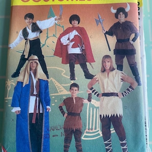 May include: A sewing pattern for five different costumes. The pattern includes a knight, a viking, a shepherd, a pirate, and a barbarian. The pattern is from McCall's Costumes and is easy to sew.