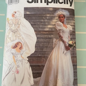 May include: Simplicity sewing pattern number 429, size K5 (8-16), for a wedding dress. The pattern shows two models wearing white wedding dresses with lace details and veils.