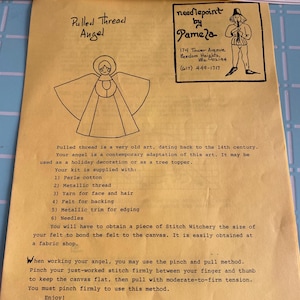 May include: A yellow paper with the text "needlepoint by pamela" at the top. The paper includes a drawing of an angel, instructions, and a list of supplies for a pulled thread angel kit. The kit includes perle cotton, metallic thread, yarn, felt, trim, and needles.