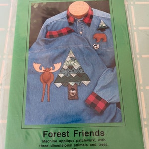 May include: A pattern for a denim shirt with applique patchwork featuring a moose, a tree, a bear, and a raccoon. The pattern is titled "Forest Friends" and is number 7.