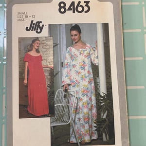 May include: A vintage Simplicity sewing pattern envelope, featuring a floral print dress and a red dress. The envelope is labeled "8463" and includes the "Jiffy" logo. The size is listed as "Small" for sizes 10-12.