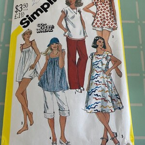 May include: Simplicity sewing pattern number 5513 for maternity wear. The pattern includes five different styles: a striped top with cuffed pants, a red top with pants, a red and white patterned top with shorts, a white top with shorts, and a blue and white patterned dress. The pattern is for sizes 16 maternity.