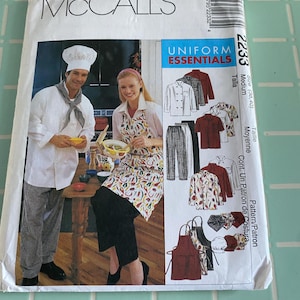 May include: A sewing pattern for a chef's uniform, featuring a white chef's jacket, black pants, a red apron, and a white chef's hat. The pattern is from McCall's Uniform Essentials and is size 38-40, medium.
