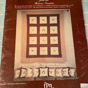 May include: A vintage book cover for a counted cross stitch pattern titled "Calico Patches from the Botanic Sampler". The cover features a quilt design with floral motifs and a handwritten signature "Connie Helms". The book is published by Freeman-Pierce & Norris, Inc.