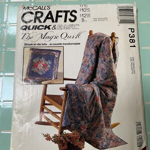May include: A McCall's Crafts pattern envelope for "The Magic Quilt." The cover features a floral patterned quilt draped over a wooden rocking chair. The pattern includes instructions for a transformable quilt. The envelope is labeled P381.