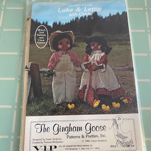 May include: A package for a doll pattern set. The cover features two dolls, Luke and Lettie, with chicks. The dolls are dressed in vintage-style clothing. The text on the package reads "The Gingham Goose Patterns & Pretties, Inc."