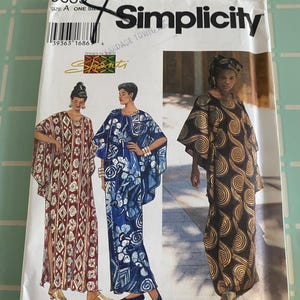 May include: Simplicity sewing pattern #9659 featuring three women's dresses with different patterns. The pattern envelope is white with the Simplicity logo and the text "Designs by Shanti". The dresses are long, flowing, and have unique designs.
