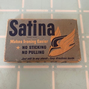 May include: A blue and white box with the text "Satina Trade Mark Makes Ironing Easier NO STICKING NO PULLING Just add to any starch. Easy directions inside."