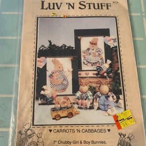 May include: A craft pattern for a wall hanging featuring a girl and boy bunny with a wagon full of baby bunnies. The pattern is called "Carrots 'N Cabbages" and includes 7 inch chubby girl and boy bunnies, lots of baby bunnies, and a 9 by 13 inch fuseable dimensional wall hanging.